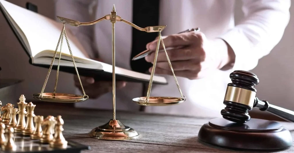 Gavel On Wooden Table And Lawyer Or Judge Working With Agreement In Courtroom Theme 1024x535